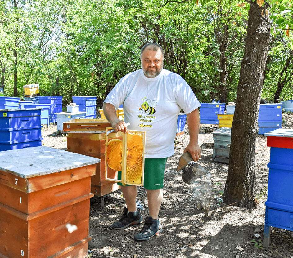 beekeeper Iliyan Stratiev among his apiary