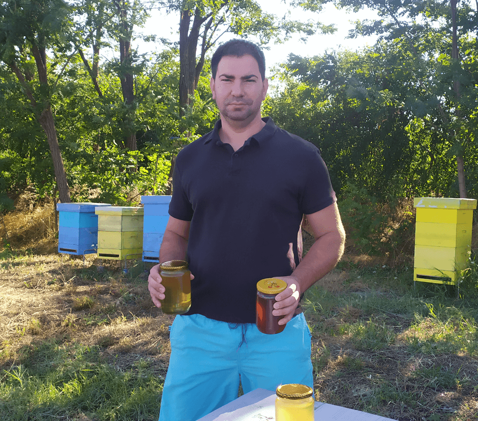 beekeeper Todor Ivanov with jars of honey from his production